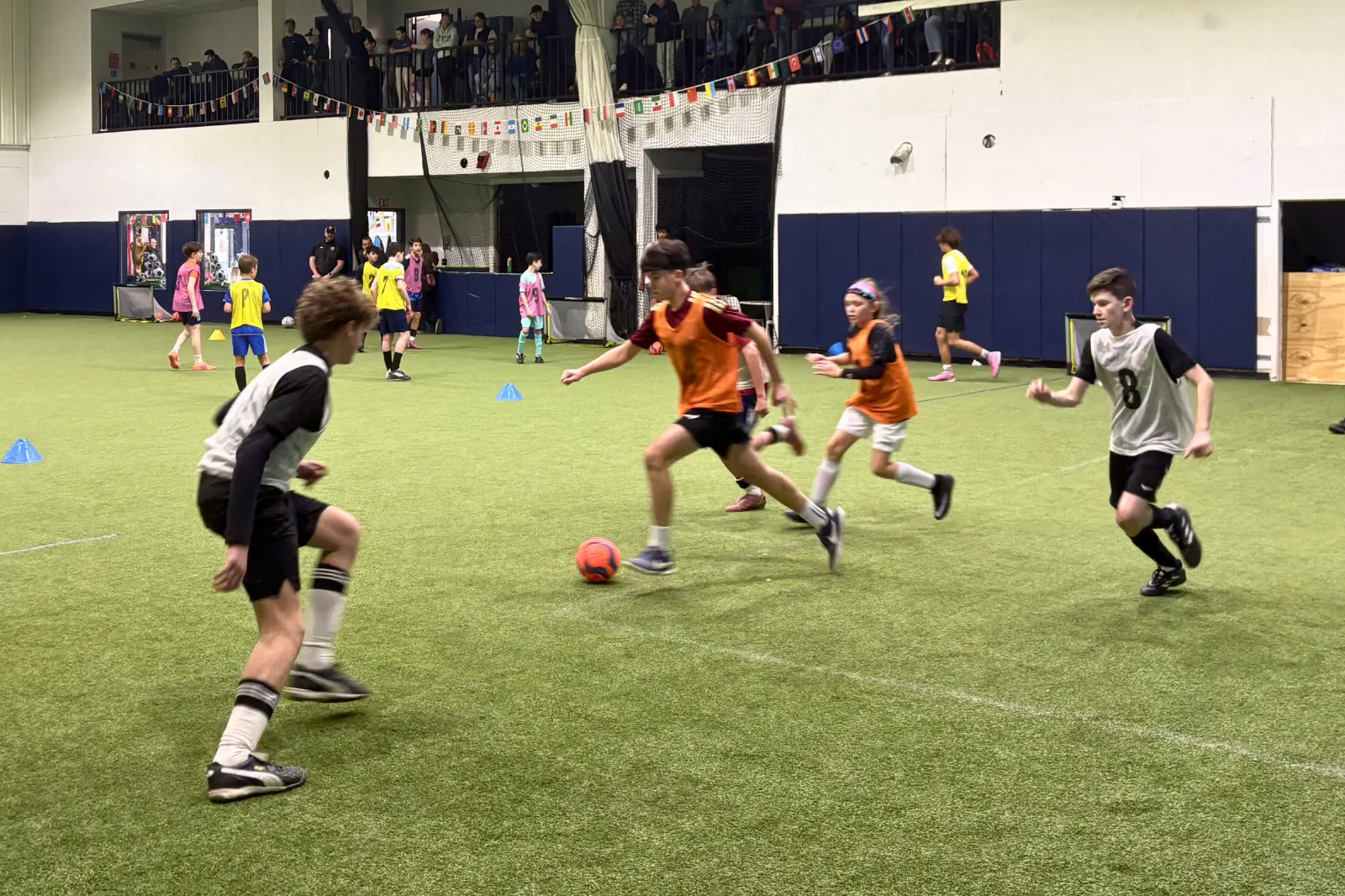 Focused teenage athletes training under coaching at Bedford Field House.