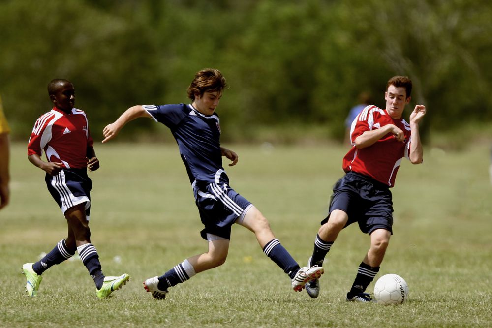 Focused teenage athletes training under coaching at Bedford Fieldhouse Ascend program.